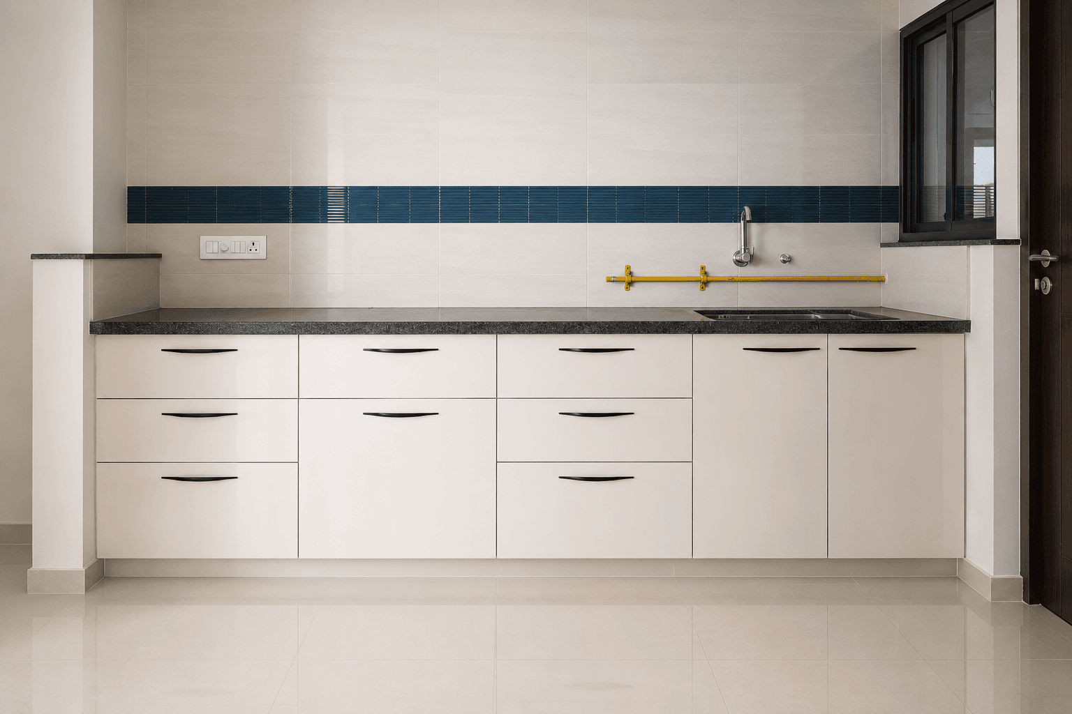 A modern kitchen with glossy white cabinetry and a bold tile accent