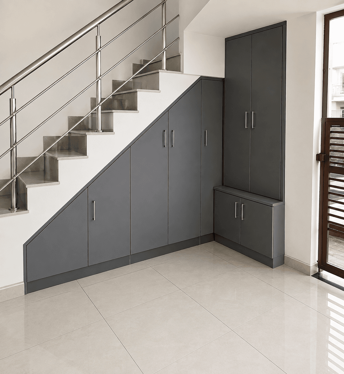 Custom charcoal storage cabinetry built under a staircase